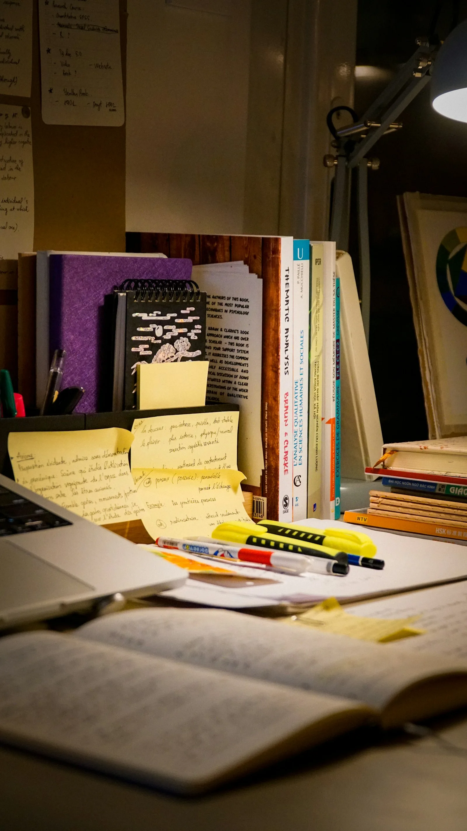 Research notes and books gathered on a working desk